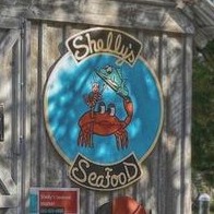 The hand-painted Shelly's Seafood sign on the wall of the fish house.